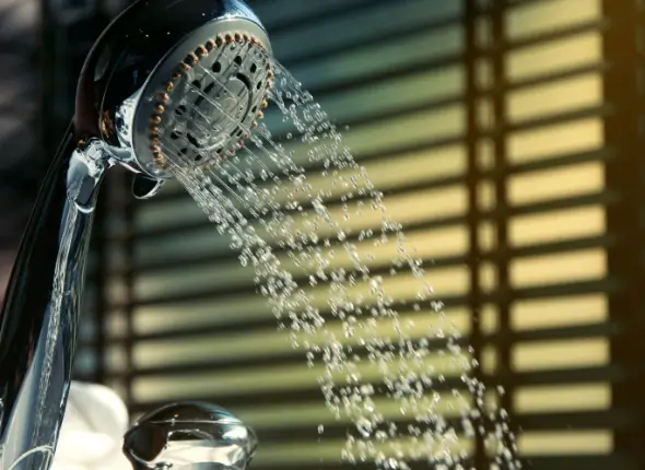 26525603 Professional plumber adjusting shower pressure. We Fix Plumbing offers expert shower pressure adjustment service in London.