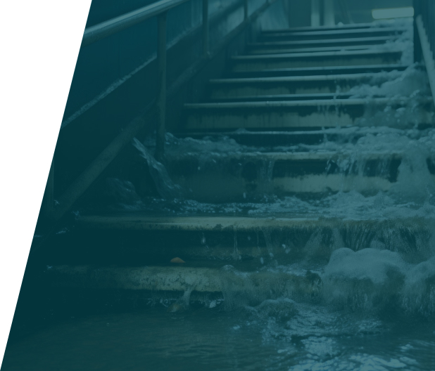 Plumber repairing an overflowing pipe in a residential bathroom, showcasing overflows emergency service in London by We Fix Plumbing London.