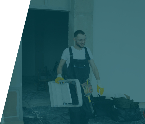 Plumber cleaning a flooded basement with a hose, representing basement flood clean-up service in London by We Fix Plumbing London.