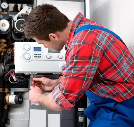HVAC-technician-servicing-a-boiler-heater-1024x699 HVAC technician servicing a boiler heater, representing boiler repair service in London by We Fix Plumbing London.