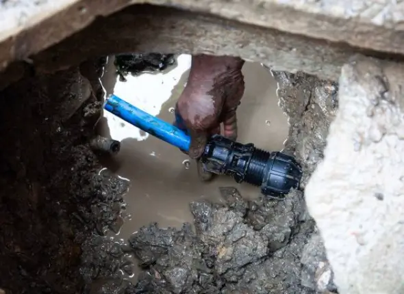 Technician inspecting lead pipes for replacement, highlighting lead pipe replacement service in London by We Fix Plumbing London