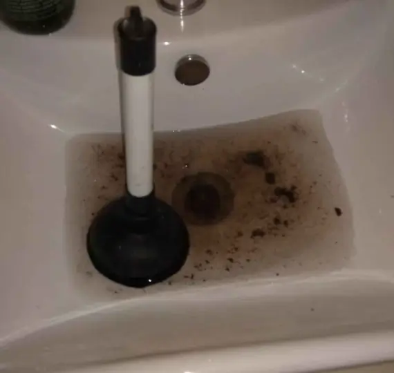 blocked-drains Plumber using a high-pressure water jet to clear a blocked drain, highlighting blocked toilets, sinks, pipes, and drains service in London by We Fix Plumbing London.