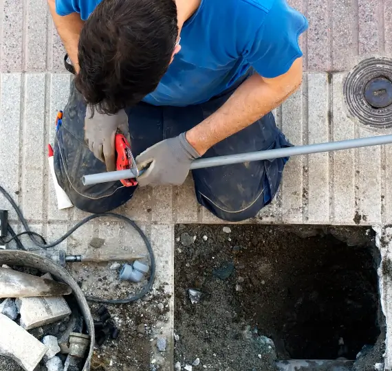 Plumber examining and replacing lead pipes, illustrating lead pipe replacement service in London by We Fix Plumbing London.
